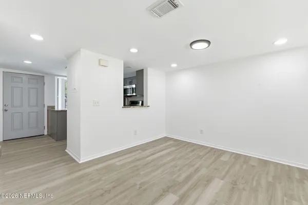 a view of a dining room with furniture and wooden floor