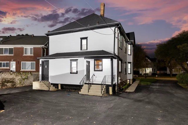a view of a large white building among the street