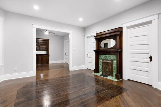 a view of an empty room with a fireplace and a window