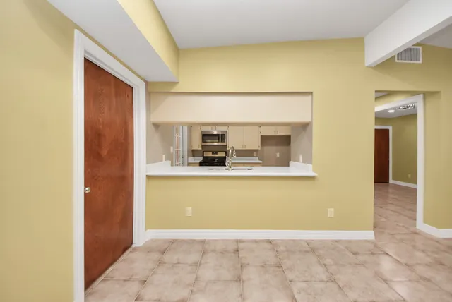 a kitchen with a sink stove and cabinets