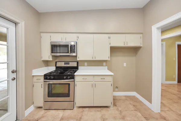 a kitchen with a stove and a microwave
