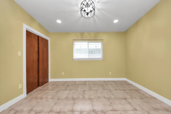 a view of an empty room with a ceiling fan