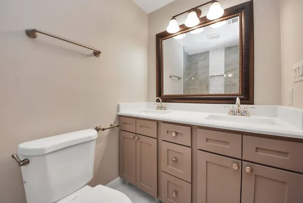 a bathroom with a sink vanity and a mirror