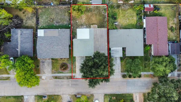 an aerial view of a house with a yard and garden