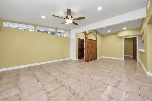 a view of a livingroom with a ceiling fan and entryway