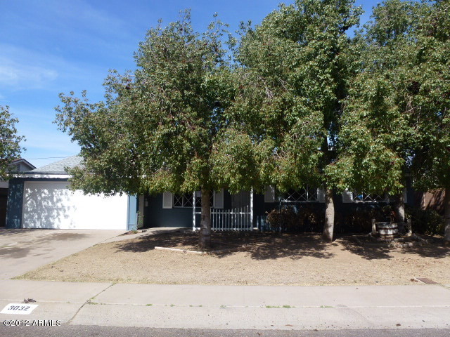 3032 West Bloomfield Road Phoenix, AZ 85029 - Photo 1 of 32 a view of a house with a tree in front of it