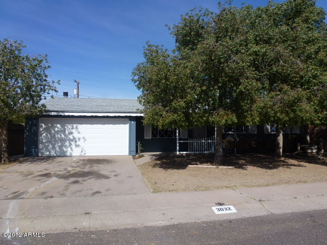 3032 West Bloomfield Road Phoenix, AZ 85029 - Photo 2 of 32 a view of a house with a yard and garage