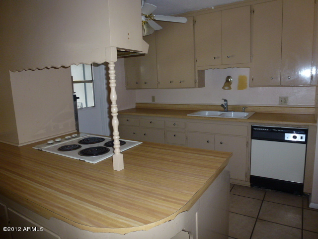 3032 West Bloomfield Road Phoenix, AZ 85029 - Photo 25 of 32 a kitchen with a sink a stove and cabinets
