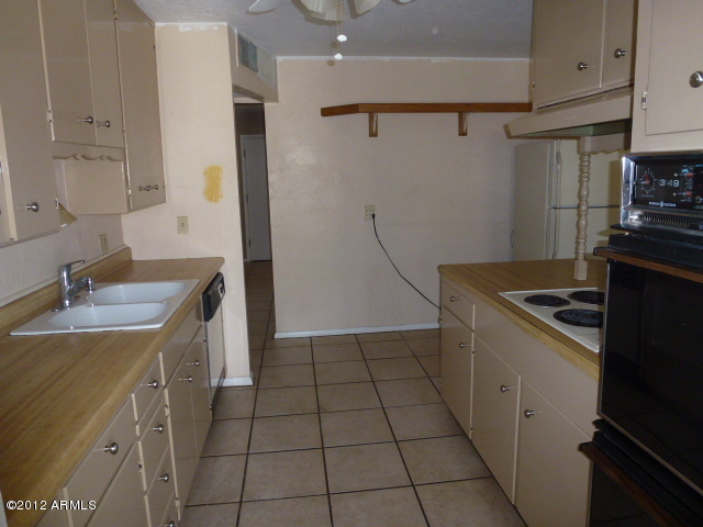 3032 West Bloomfield Road Phoenix, AZ 85029 - Photo 27 of 32 a kitchen with a sink appliances and cabinets