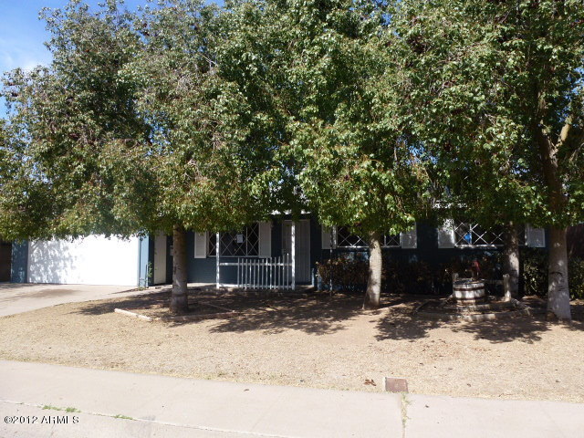 3032 West Bloomfield Road Phoenix, AZ 85029 - Photo 5 of 32 a tree in front of a white house