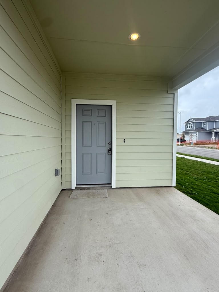 2601 Foss Road Manor, TX 78653 - Photo 6 of 40 A sheltered concrete porch leads directly to the welcoming main entrance of this residence.