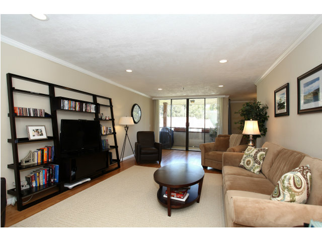 1115 Continentals Way, Unit 203 Belmont, CA 94002 - Photo 1 of 16 a living room with furniture a air conditioner and a book shelf
