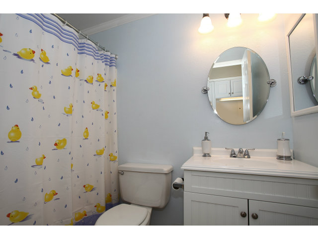 1115 Continentals Way, Unit 203 Belmont, CA 94002 - Photo 13 of 16 a bathroom with a sink a toilet and a mirror