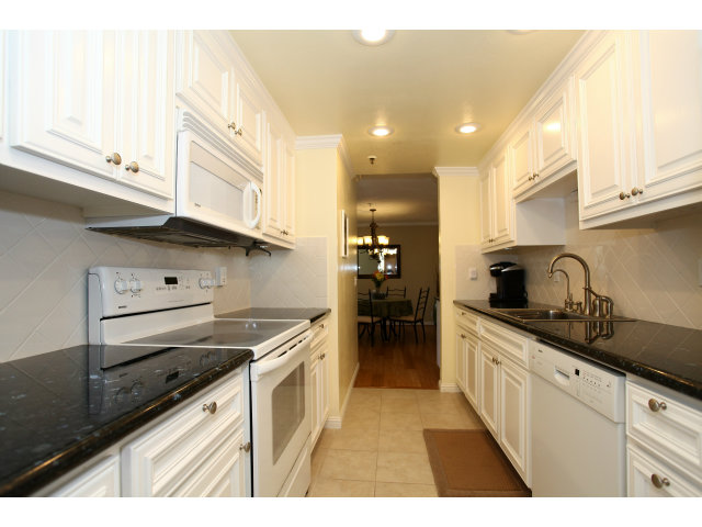 1115 Continentals Way, Unit 203 Belmont, CA 94002 - Photo 4 of 16 a kitchen with stainless steel appliances granite countertop a sink and cabinets