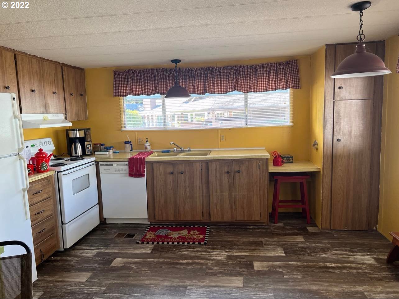 1475 Green Acres Road, Unit 142 Eugene, OR 97408 - Photo 2 of 14 a kitchen with cabinets a sink and appliances