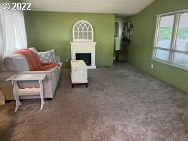 1475 Green Acres Road, Unit 142 Eugene, OR 97408 - Photo 3 of 14 a living room with furniture and a window
