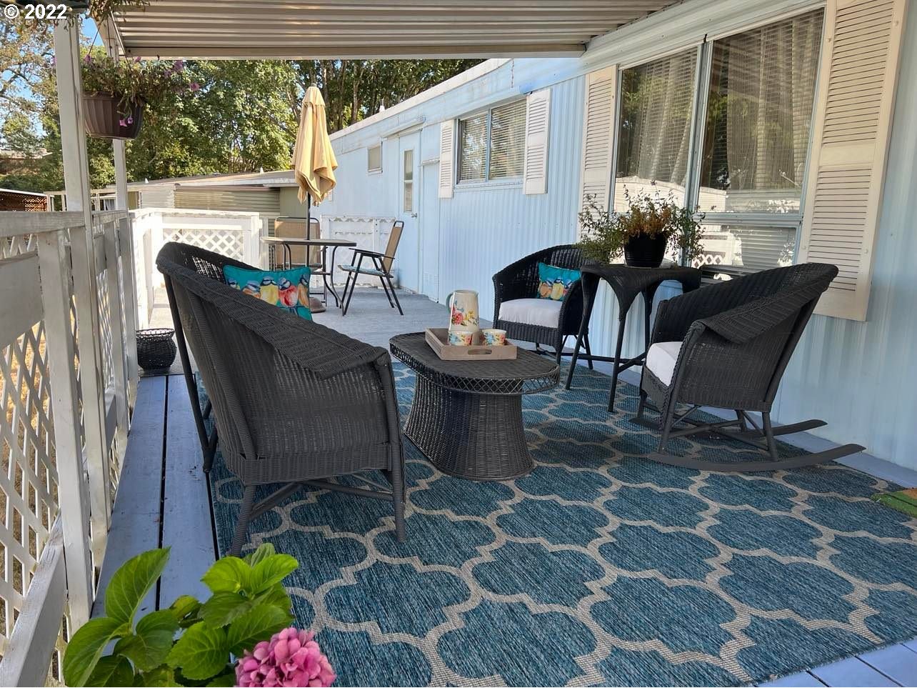 1475 Green Acres Road, Unit 142 Eugene, OR 97408 - Photo 8 of 14 a view of a patio with table and chairs and potted plants