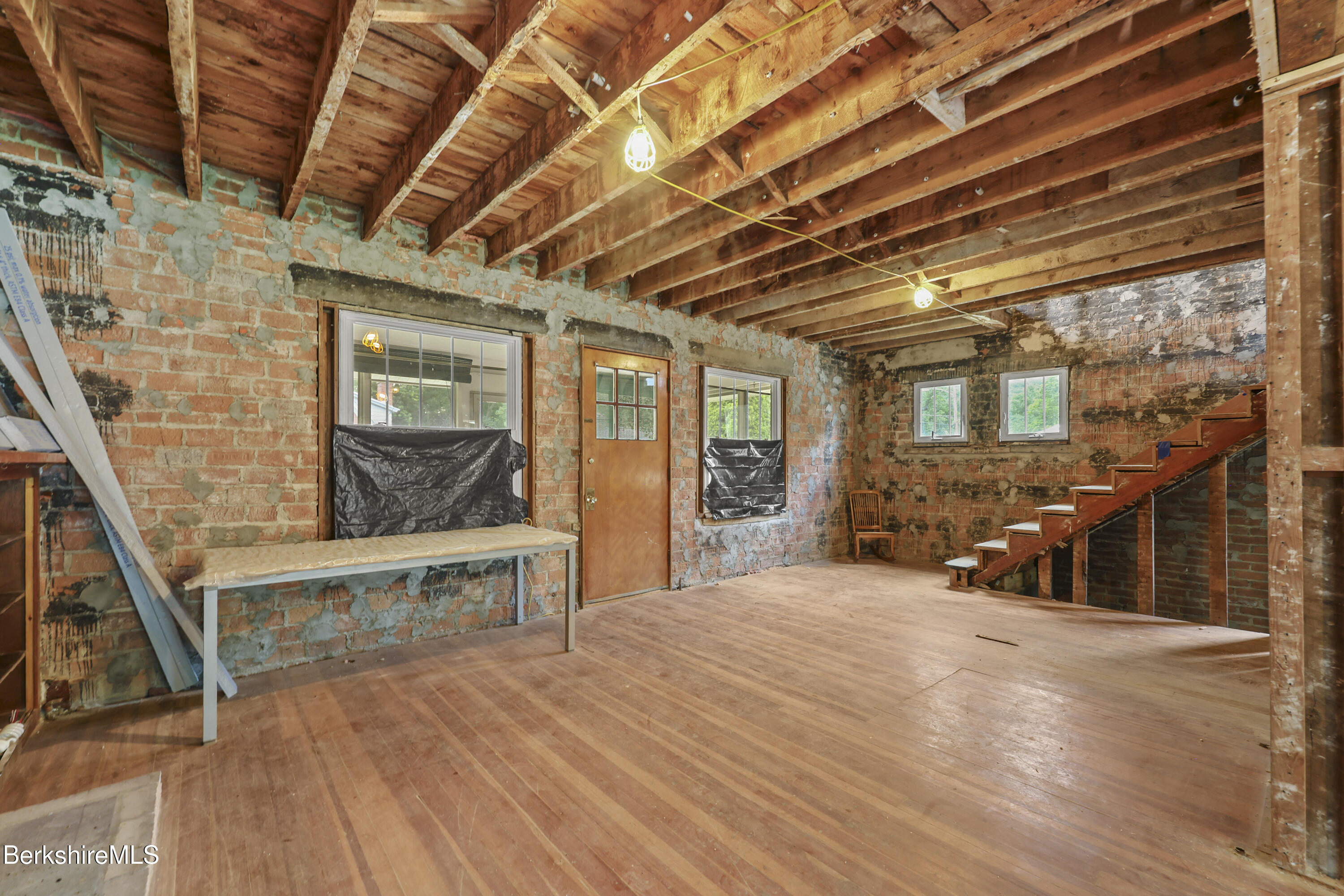 84 Notch Road North Adams, MA 01247 - Photo 8 of 30 a view of a room with wooden walls and iron stairs