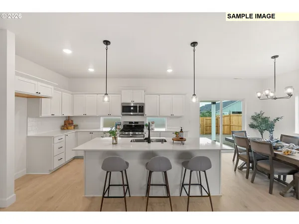 a kitchen with stainless steel appliances kitchen island granite countertop a stove a sink a microwave a counter top space and cabinets