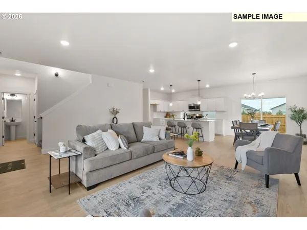 a living room with furniture a fireplace and dining table
