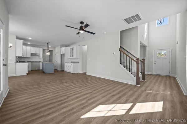 a view of empty room with wooden floor and fireplace