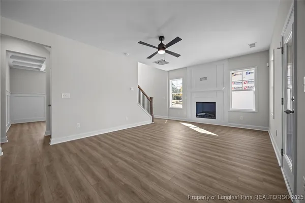 wooden floor in an empty room with a fireplace