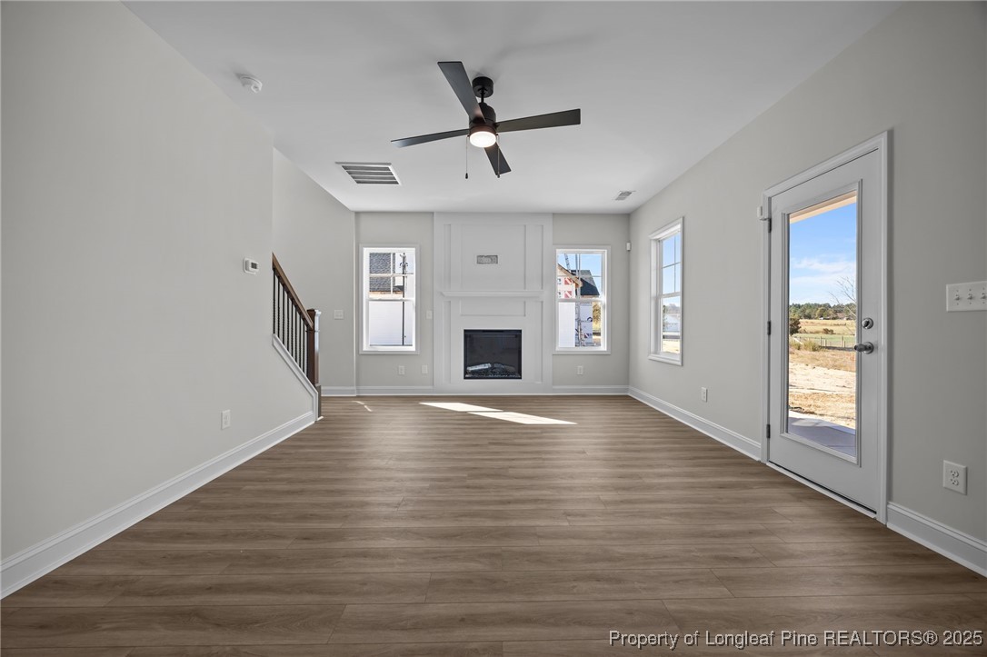 3202 Cameron Hill Road Cameron, NC 28326 - Photo 16 of 45 wooden floor in an empty room with a fireplace