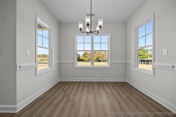 a view of a kitchen with furniture and wooden floor
