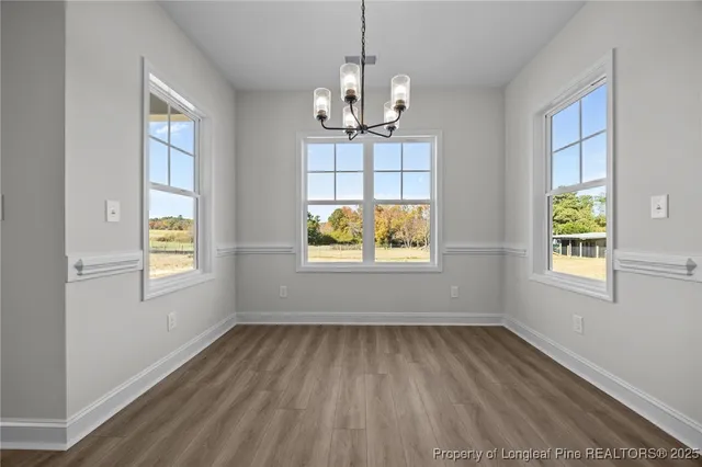 a view of a kitchen with furniture and wooden floor