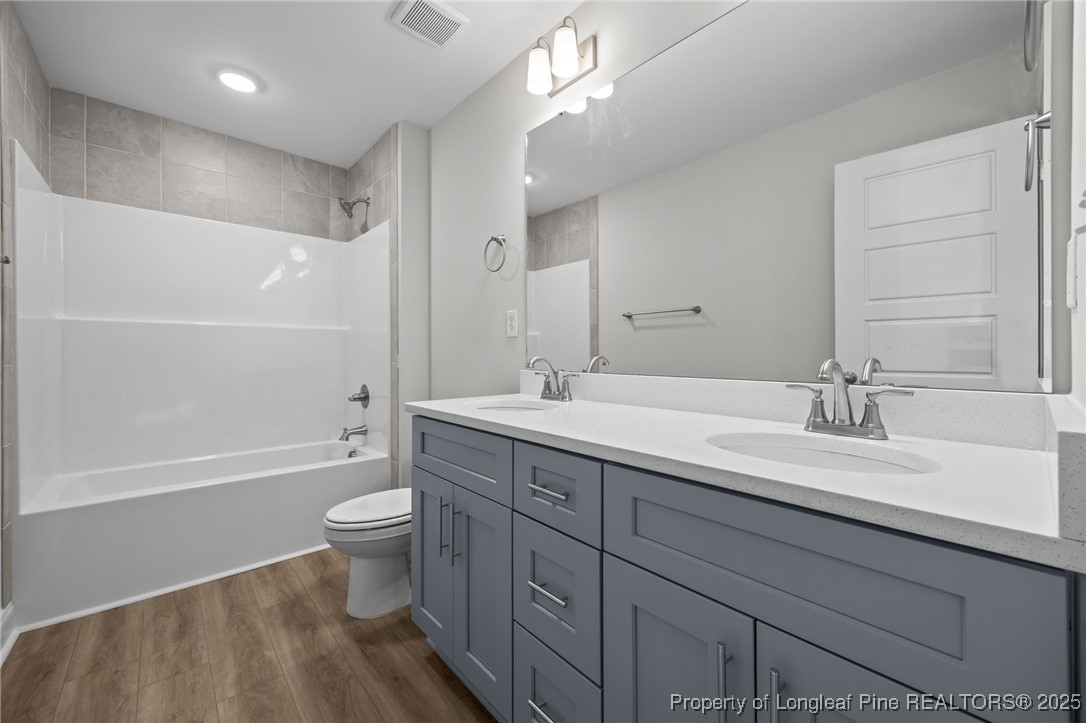 3202 Cameron Hill Road Cameron, NC 28326 - Photo 34 of 45 a bathroom with a double vanity sink toilet mirror and bathtub