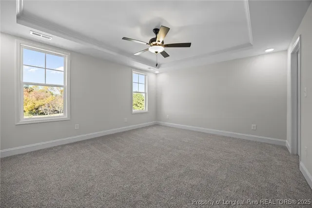 an empty room with closet and a ceiling fan