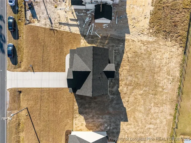 a view of a room with wooden floor chandelier and windows