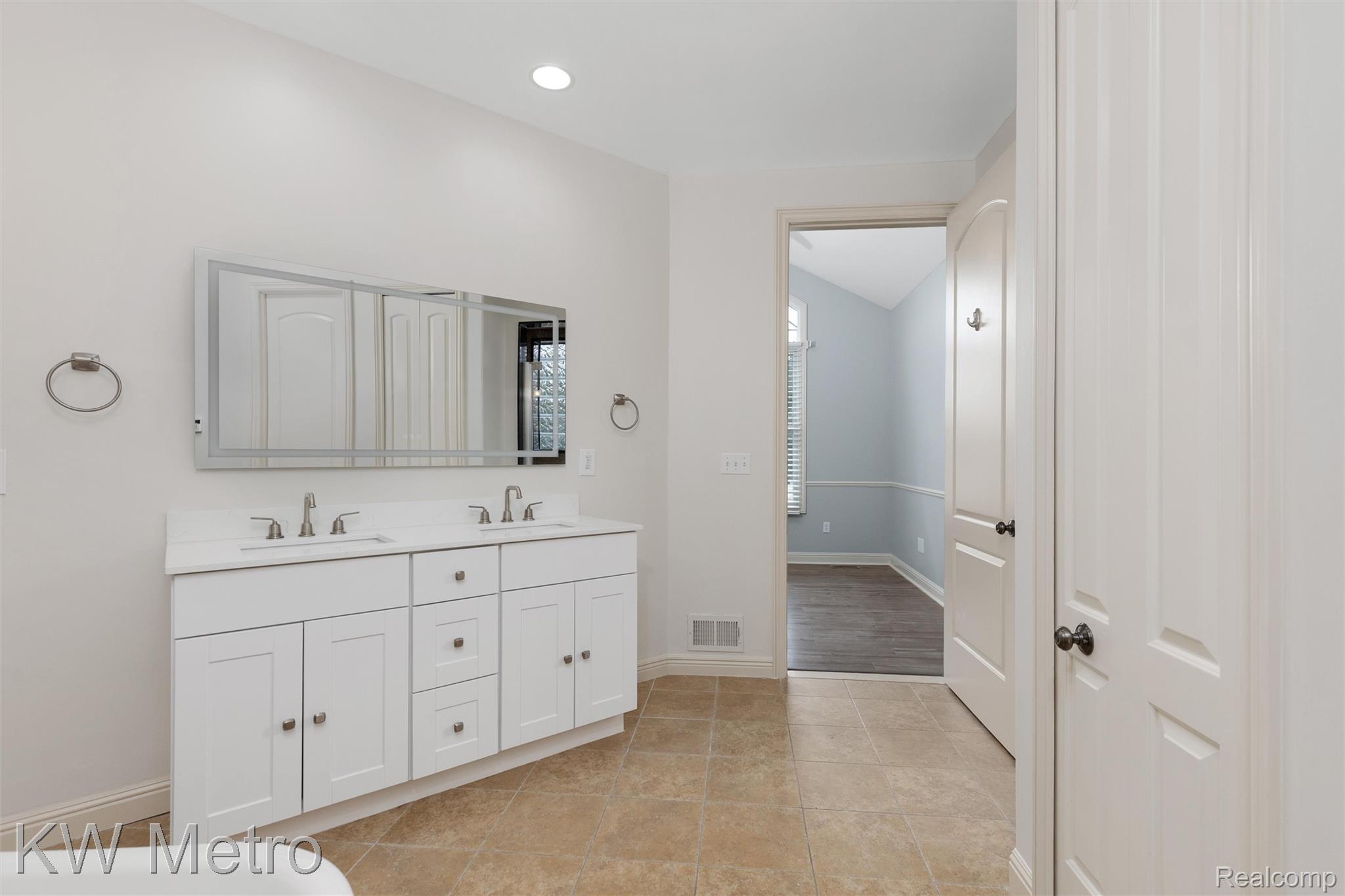 65884 Windrose Court Ray, MI 48096 - Photo 49 of 82 Full bathroom with double vanity, light tile patterned floors, and recessed lighting