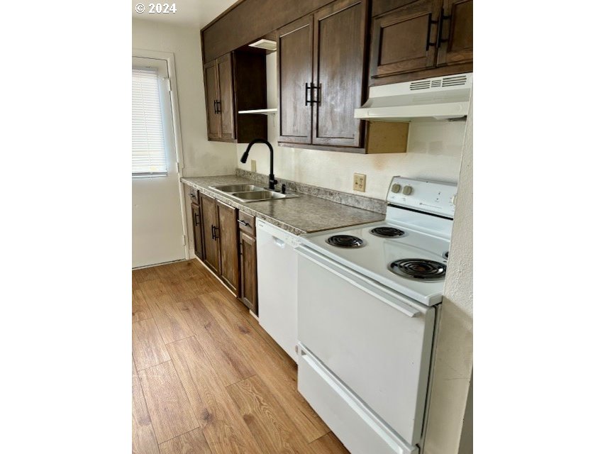219-221 Northwest 13th Street Pendleton, OR 97801 - Photo 11 of 16 a kitchen that has a sink and a stove