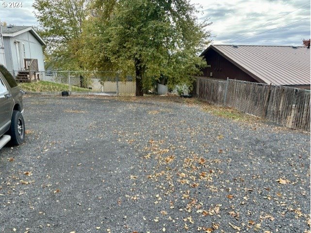 219-221 Northwest 13th Street Pendleton, OR 97801 - Photo 5 of 16 a view of a backyard with large trees and wooden fence