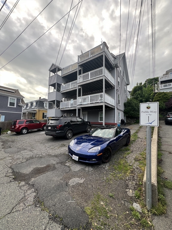 a building with parking space and a car parked