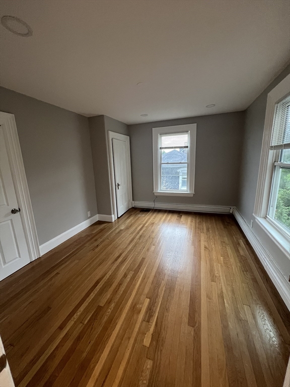 29 Ingalls Terrace, Unit 3 Swampscott, MA 01907 - Photo 11 of 13 wooden floor in an empty room with a window