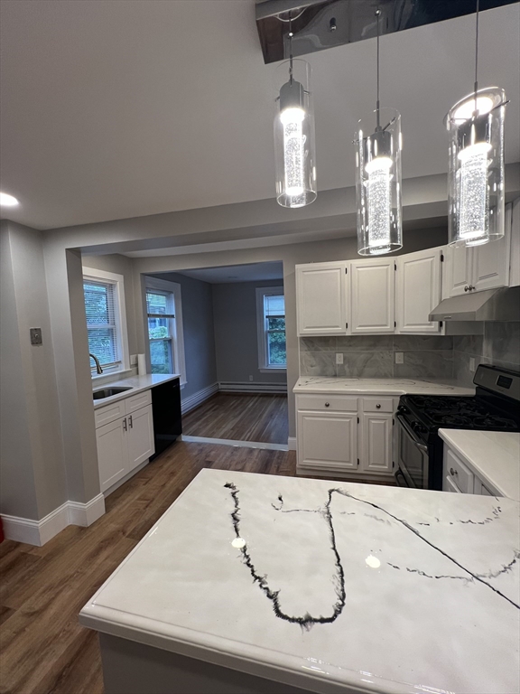29 Ingalls Terrace, Unit 3 Swampscott, MA 01907 - Photo 2 of 13 a kitchen with kitchen island granite countertop a sink cabinets and stainless steel appliances