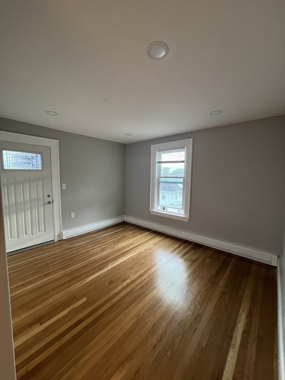 29 Ingalls Terrace, Unit 3 Swampscott, MA 01907 - Photo 7 of 13 a view of an empty room with wooden floor and a window