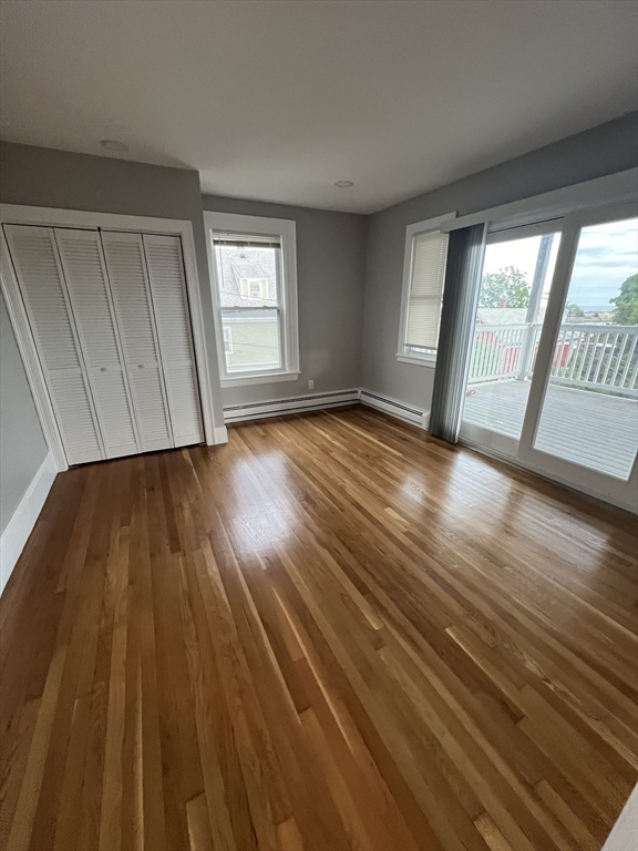 29 Ingalls Terrace, Unit 3 Swampscott, MA 01907 - Photo 8 of 13 a view of an empty room with wooden floor and a window