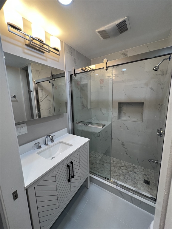 29 Ingalls Terrace, Unit 3 Swampscott, MA 01907 - Photo 10 of 13 a bathroom with a sink a toilet and shower