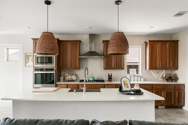a kitchen with stainless steel appliances granite countertop a sink stove and cabinets
