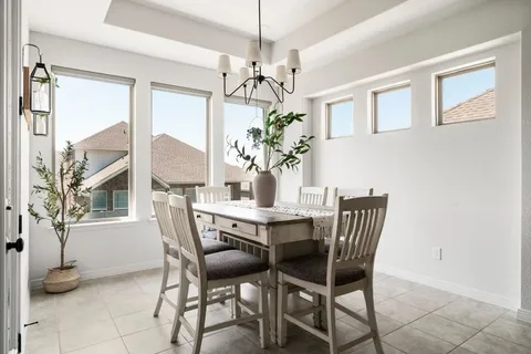 a bedroom with furniture and a large window