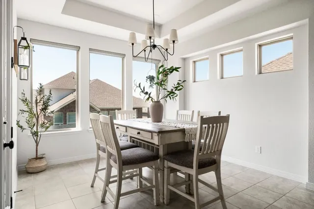 a bedroom with furniture and a large window