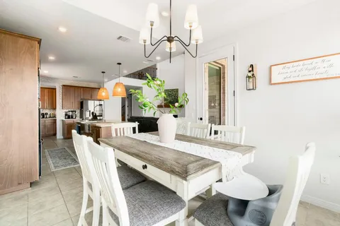 a bedroom with a balcony a bed and a chandelier