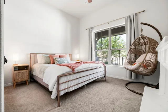 a view of a hallway to a livingroom and a balcony