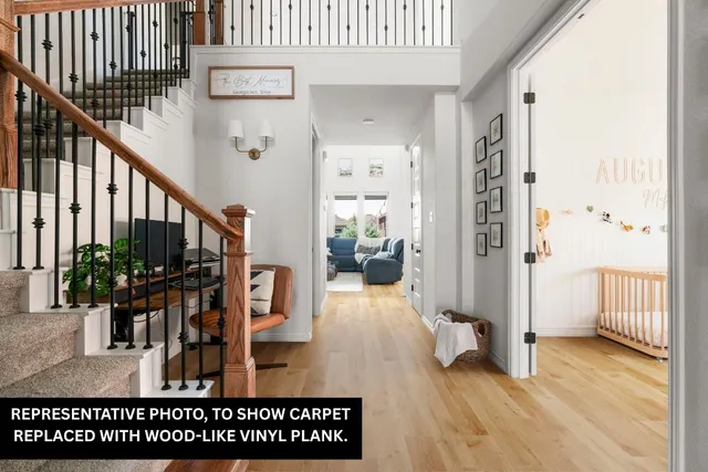 a view of living room kitchen and entryway