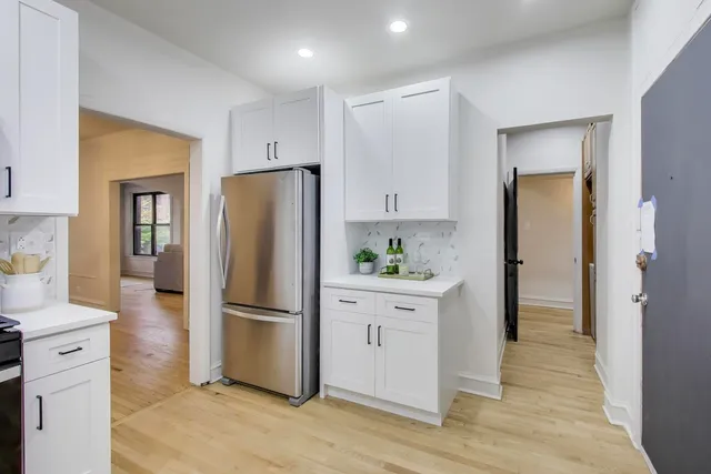 a kitchen with stainless steel appliances a refrigerator sink and cabinets