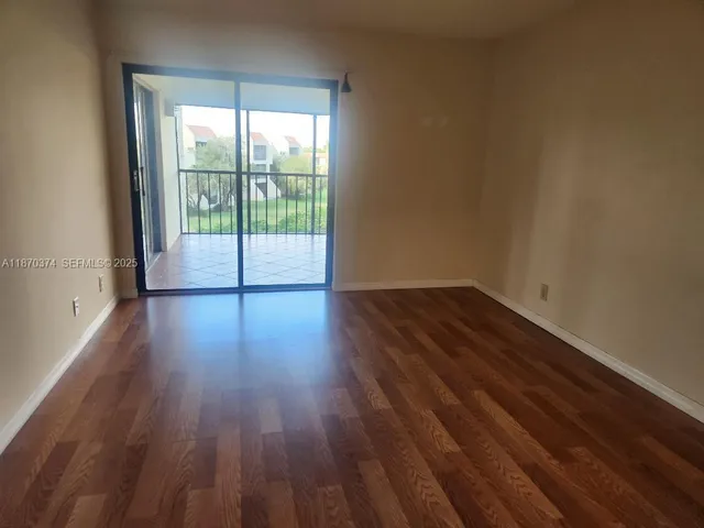 a view of wooden floor and windows in a room