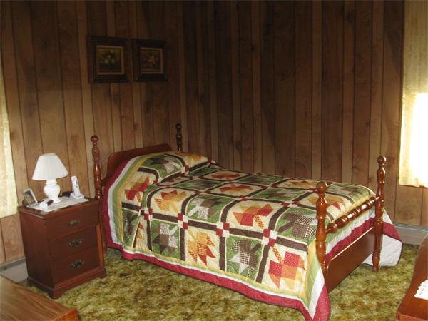 65 Oxford Street Fall River, MA 02721 - Photo 5 of 14 a bed sitting in a bedroom next to a window and a fireplace